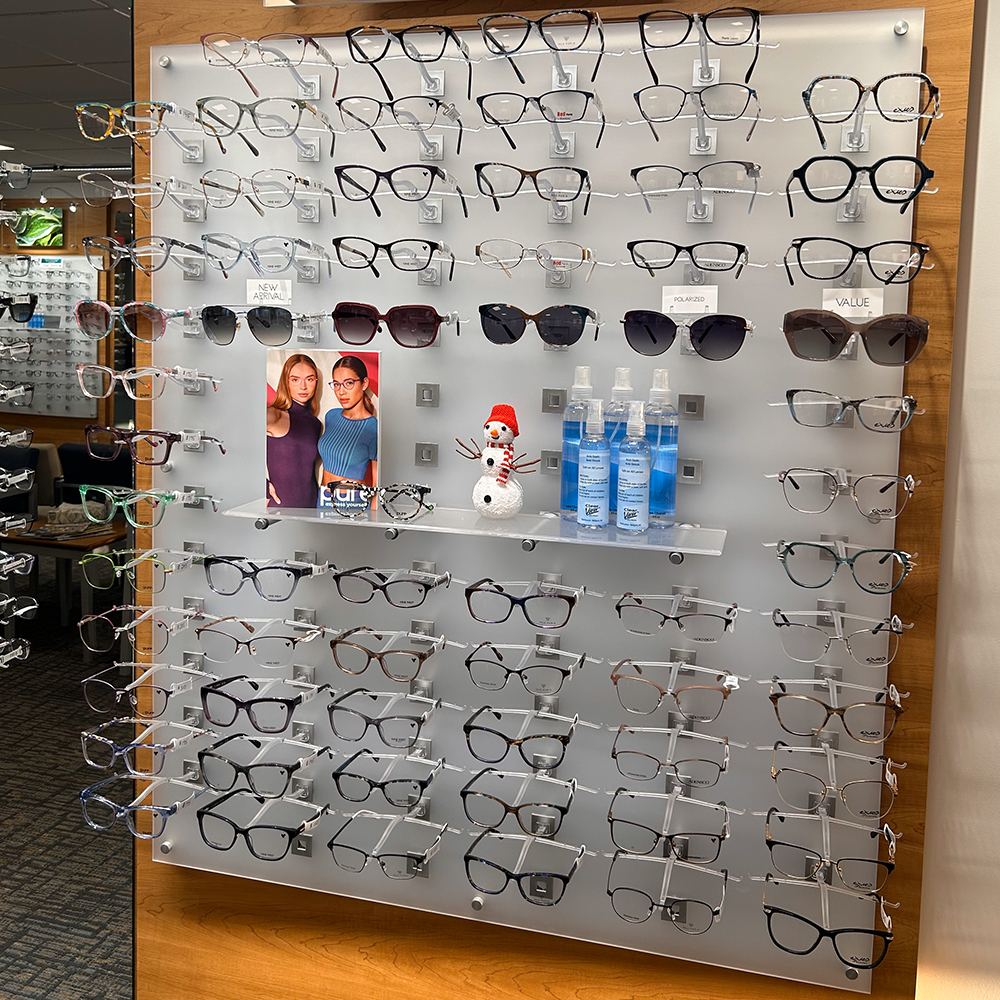 angled photo of an eyeglasses and sunglasses display in Amherst Mass at the optical shop of Eye Physicians of Northampton Eye